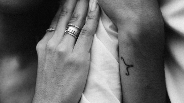 Close-up black and white image of a couple embracing, highlighting love and intimacy.